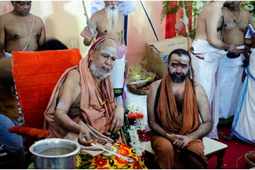His Holiness giving teerthaprasadam to devotees